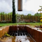 Stormwater flowing into an outdoor drain during rainfall showing proper drainage and water flow management in napier, hastings and hawke's bay