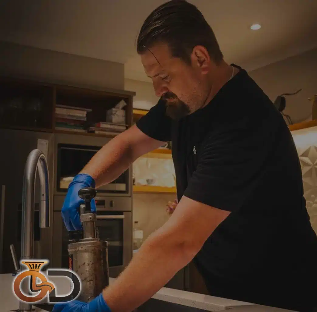 only drains technician clearing sink blockage with kinetic air gun in hastings