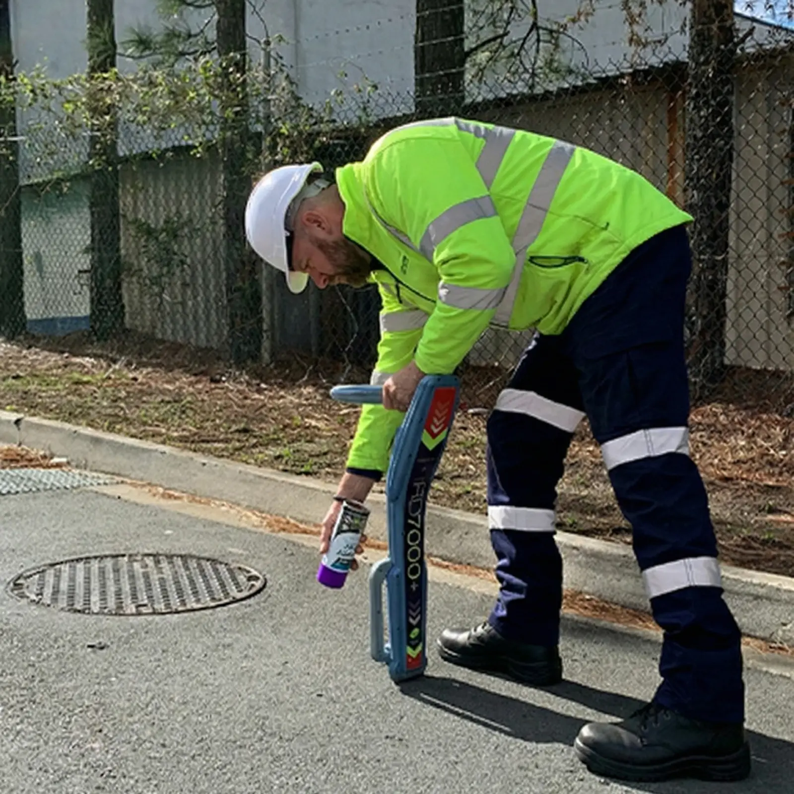 Technician using underground service locator to identify buried pipes in Napier and Hastings